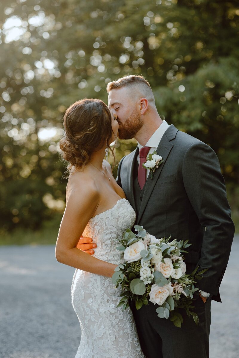 newlyweds kissing at sunset hour