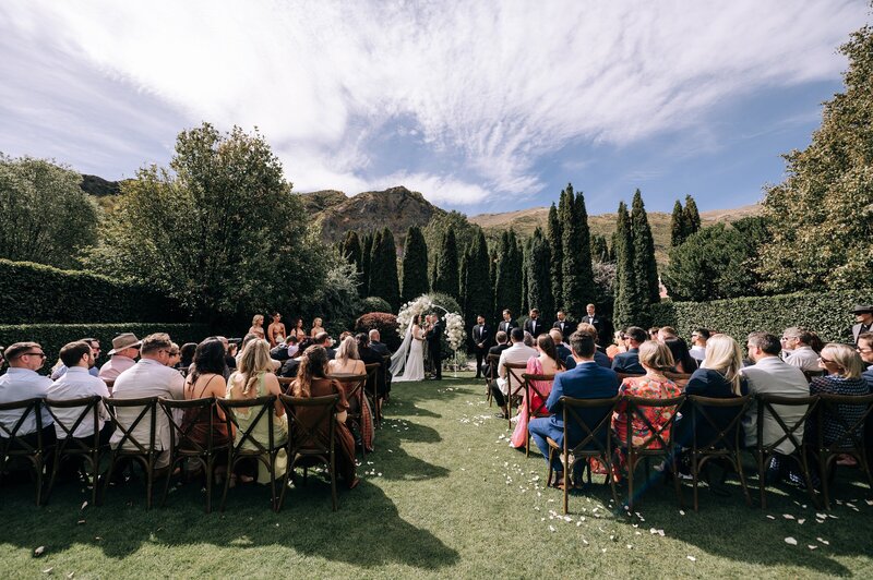 a wide photo of the winehouse queenstowns ceremony lawn on a summer day