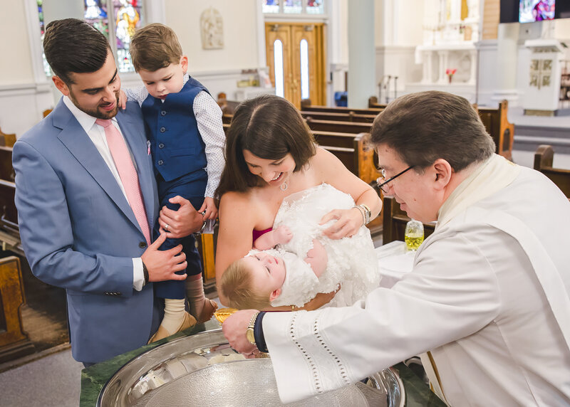 Baby girl being baptized at a church in Bergen County, NJ