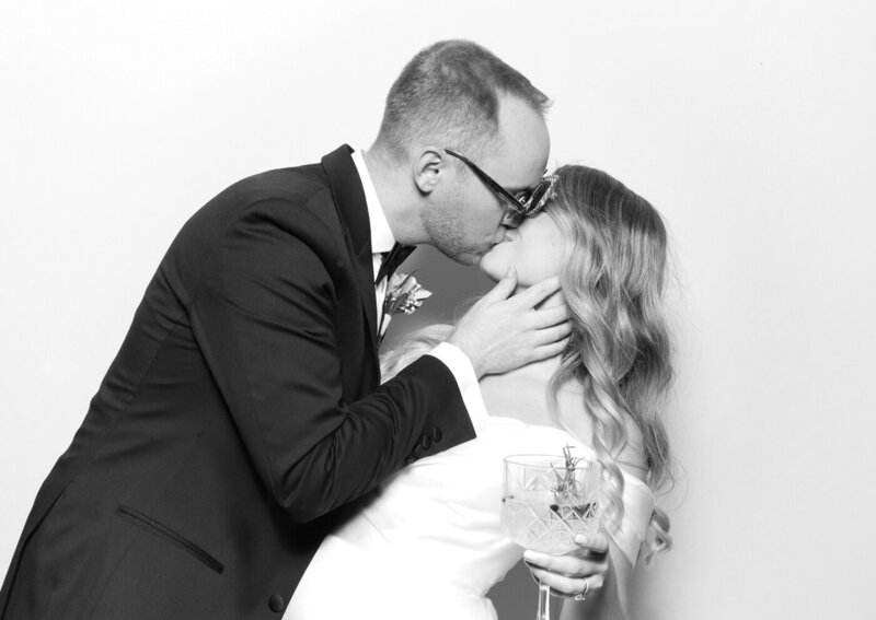 b&w image of bride and groom kissing for a kardashian glam photo booth experience 