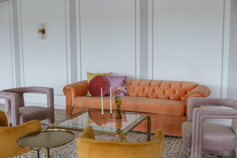 velvet lounge furniture in a white paneled room