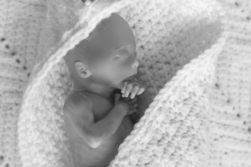 stillborn baby in crocheted bereavement cradle
