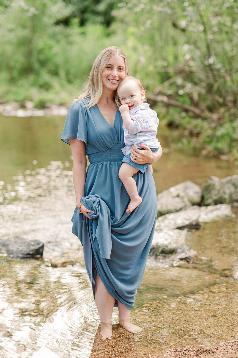 mother holding son in creek by photographers york pa
