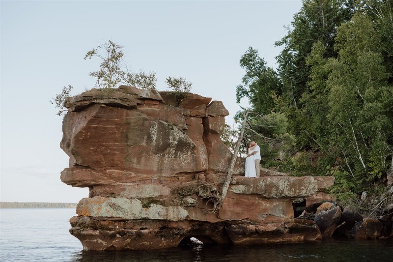 Couple eloping on a rock formation on hermit island in the apostle islands Wisconsin
