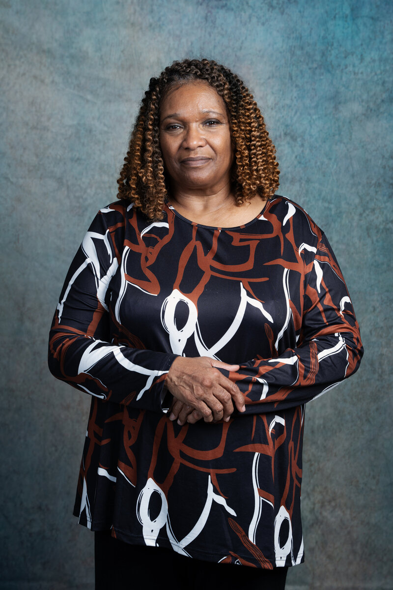 a photo of a middle aged woman in a photography studio