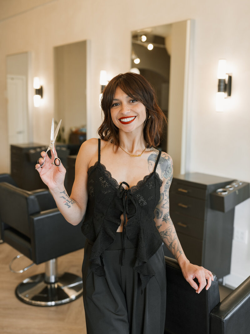 lady standing in front of rack of hair extensions