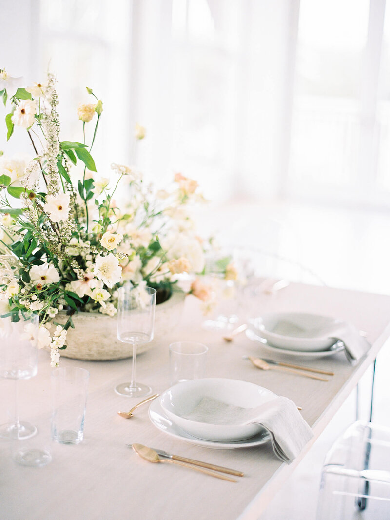 place settings at wedding reception with florals