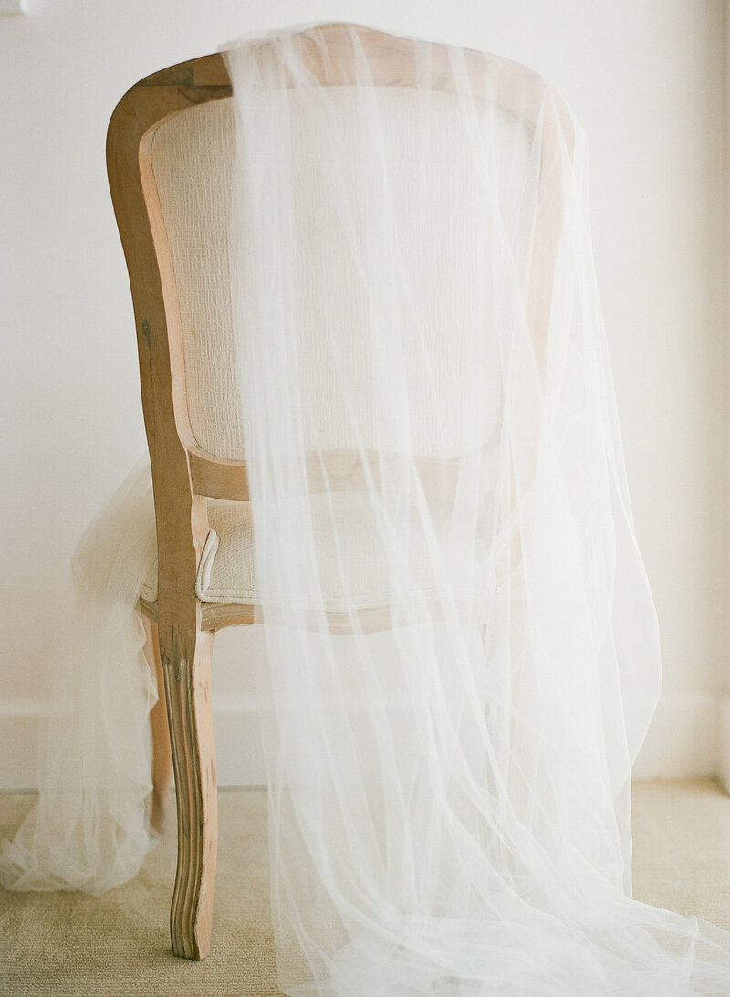 veil draped on back of elegant chair