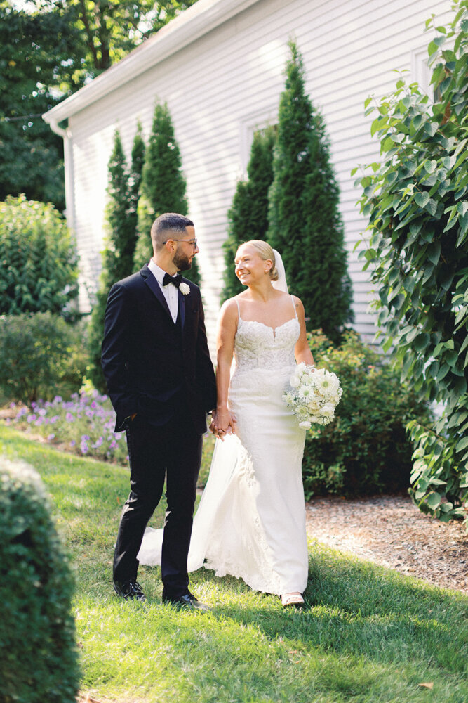 Married Couple holding hands walking in the garden