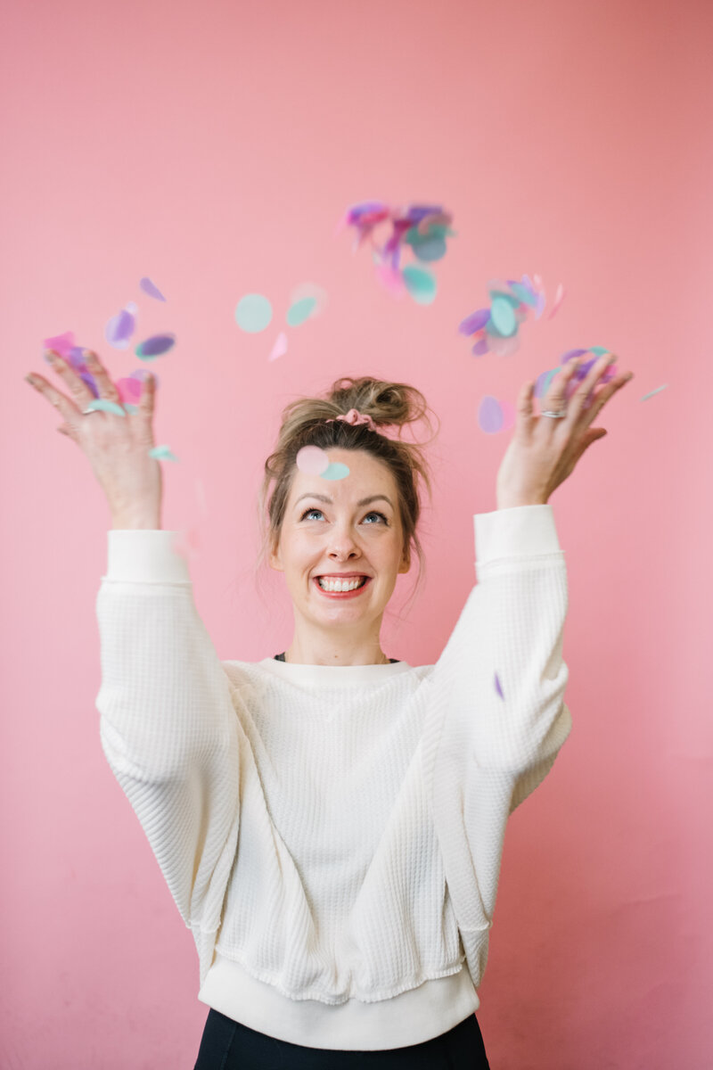 Sammy throwing confetti in front of a pink background