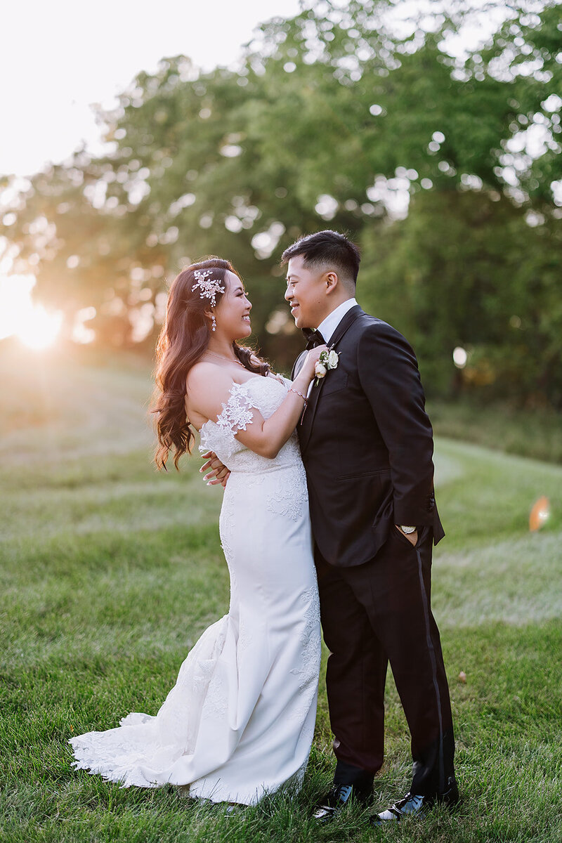 groom dips bride for a kiss in Wisconsin field at sunset