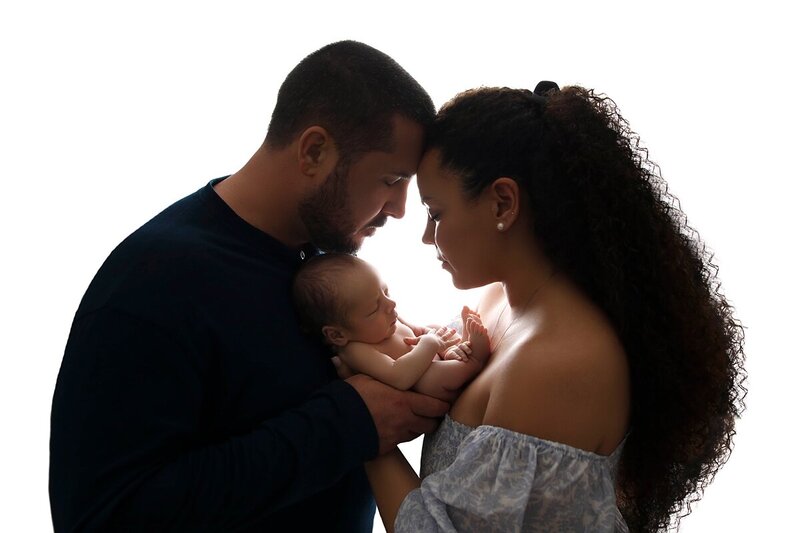 Mom and dad with baby backlit photographer orange county