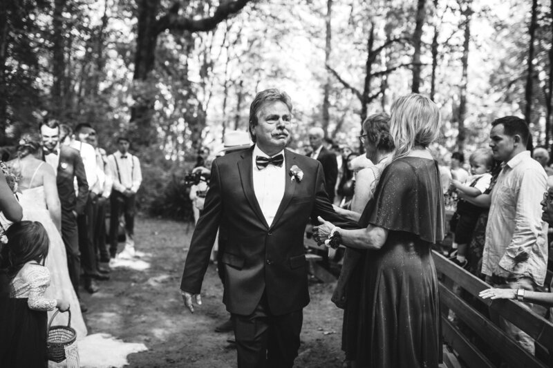 Dad crying after walking daughter down the aisle