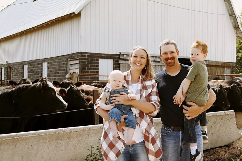 Parents with children smiling at cattle farm