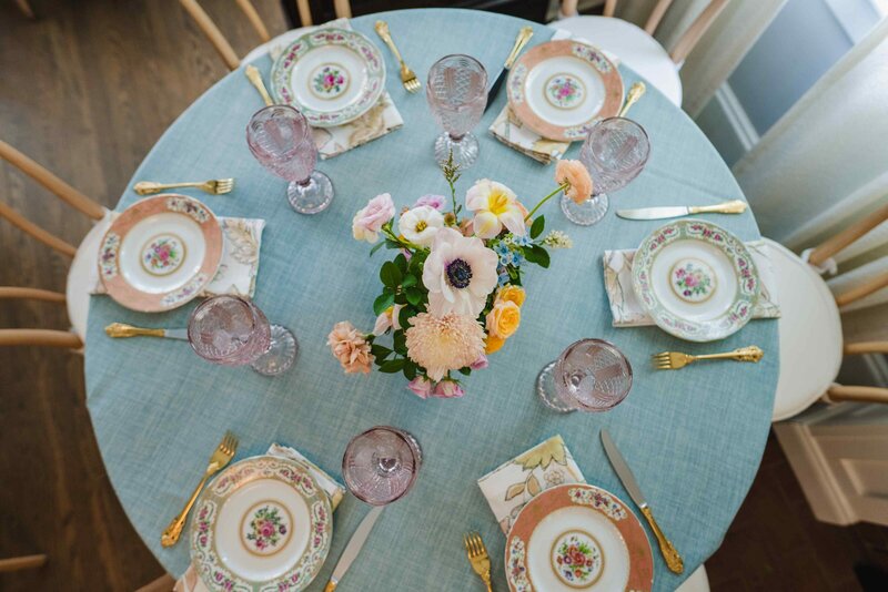 A beautifully arranged afternoon tea celebration in Montclair, NJ, showcasing vintage china, pastel table settings, and fresh floral accents.