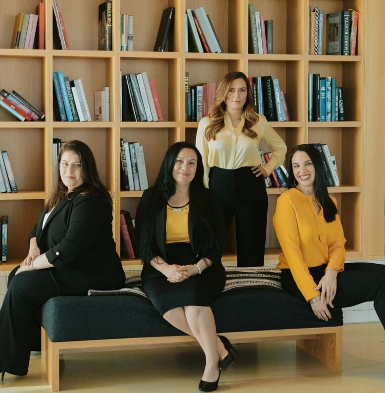 Four professionally dressed women in an office library | The clinincal Team at Relationship Experts is the most knowledgable about healing from infidelity and offers coaching to couples all over the world.