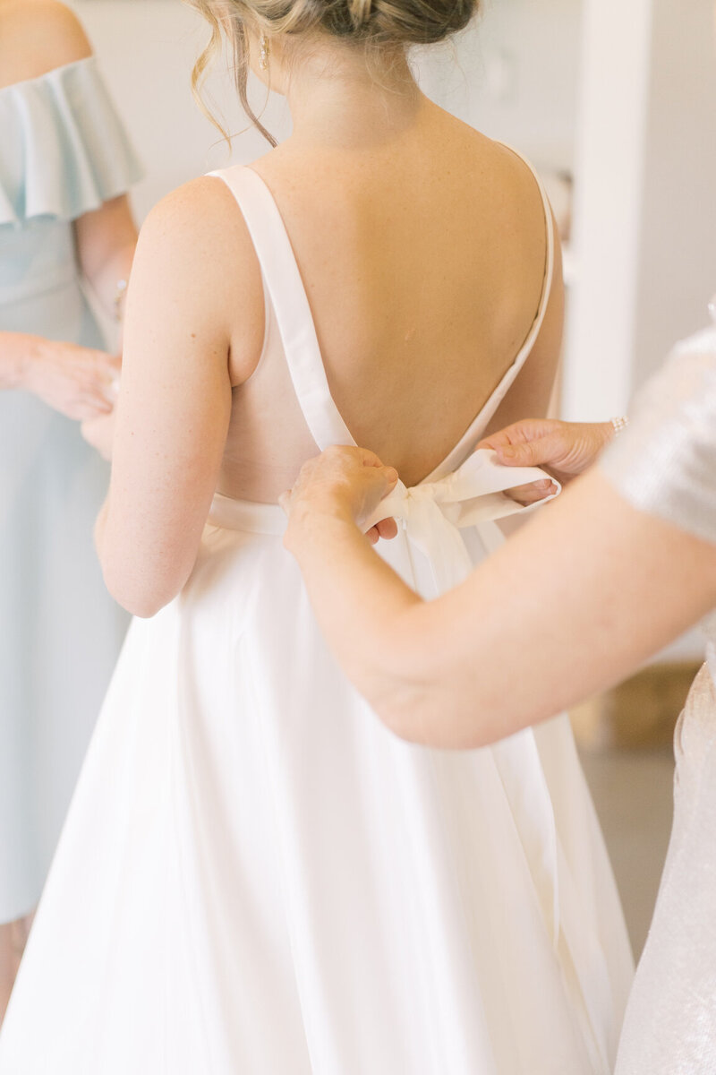 Bride getting ready in Canyonwood Ridge bridal suite with natural light and soft details