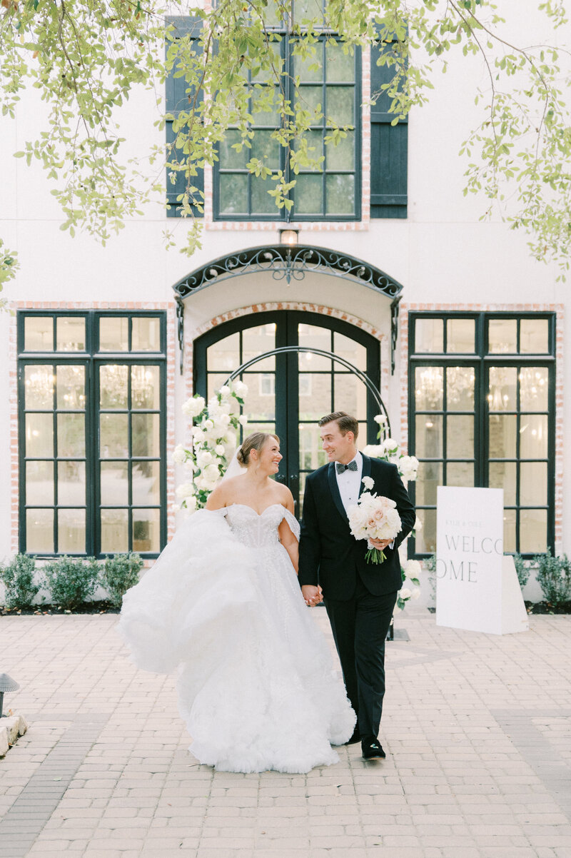 elegant bride and groom looking at each other laughing at austin wedding venue by austin wedding photographer