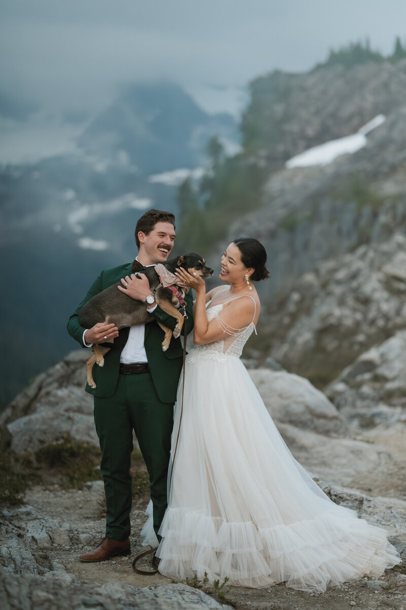 elopement couple hold their dog in their arms