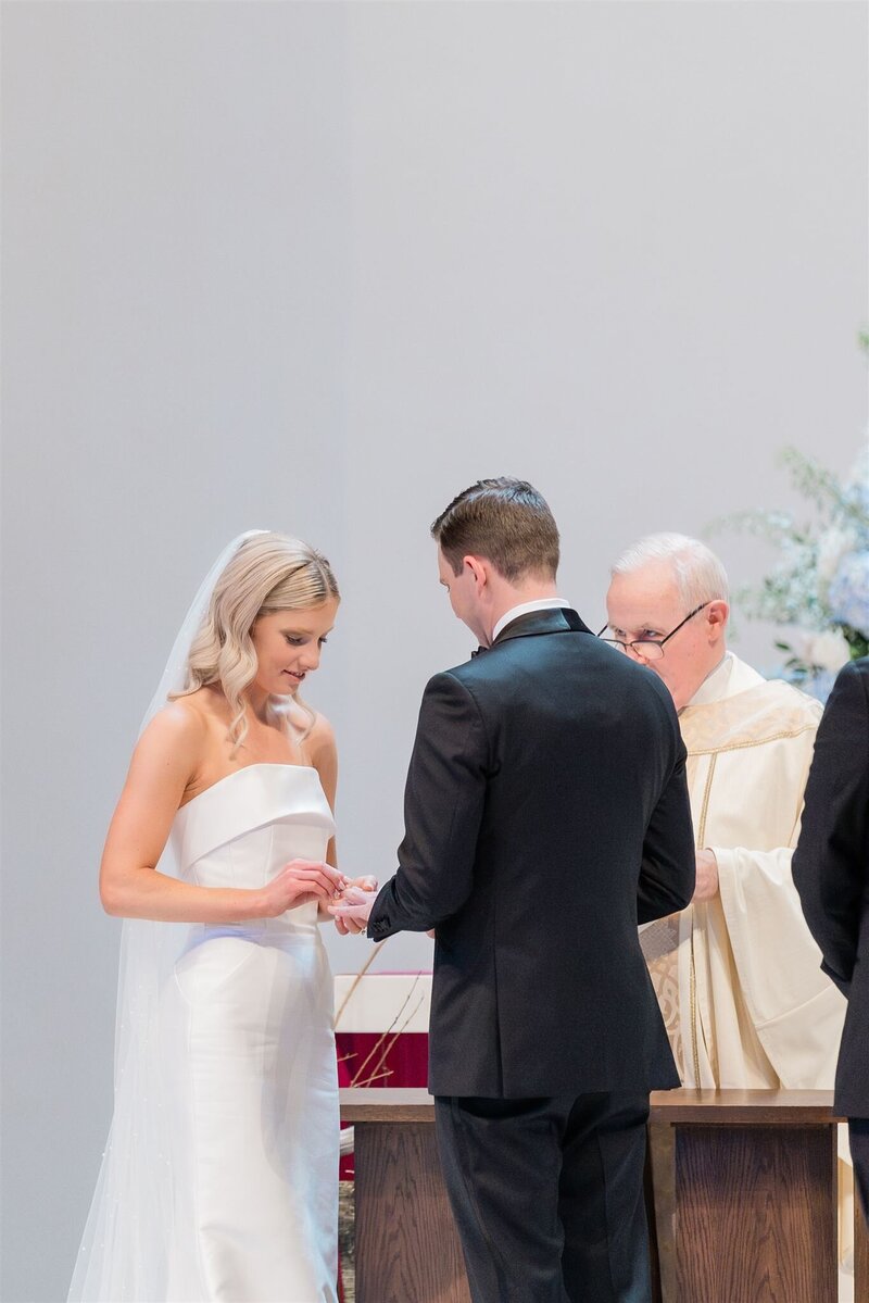 Couple at their Catholic wedding in Winter Park doing their ring exchange. 