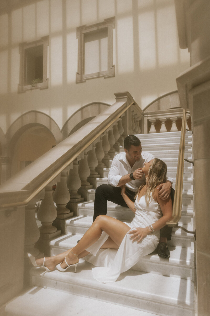 bride and groom embracing on stairs at elopement