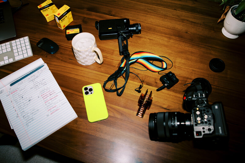 desk full of work camera equipment