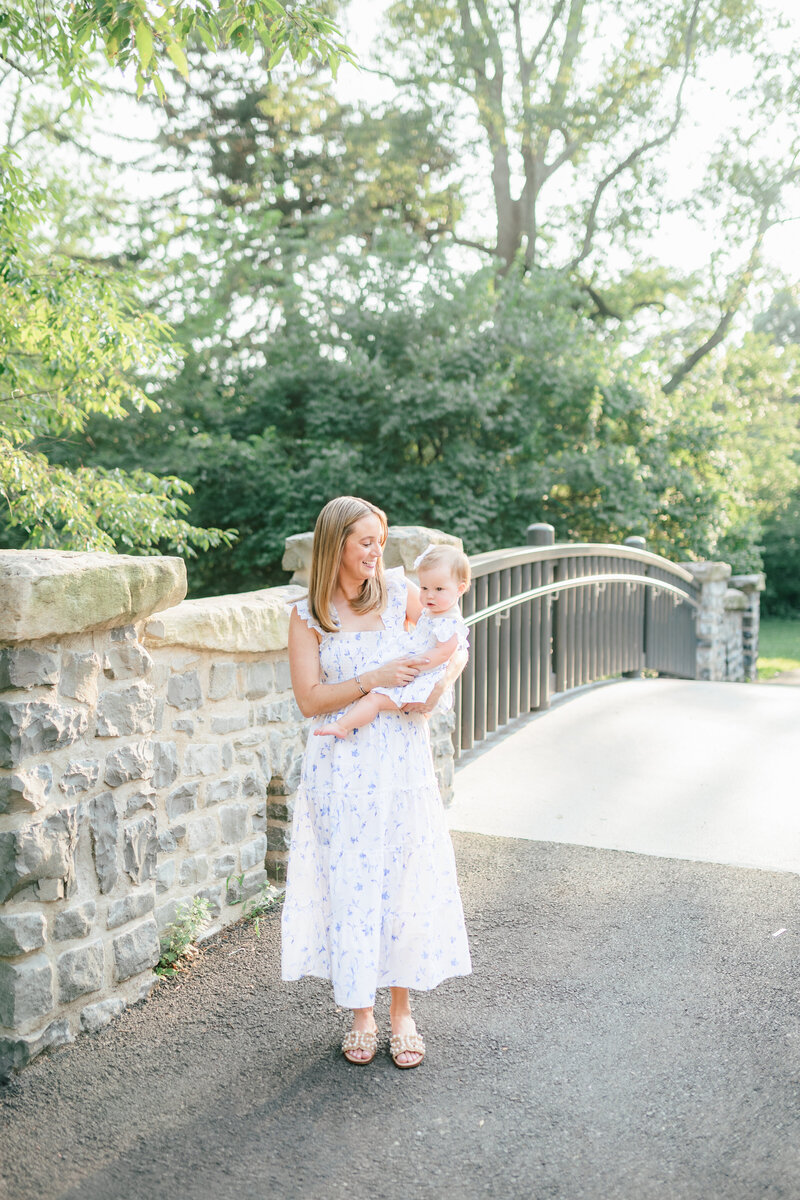 A family of 4 stands on a gravel path during their New Jersey Family Photo Session