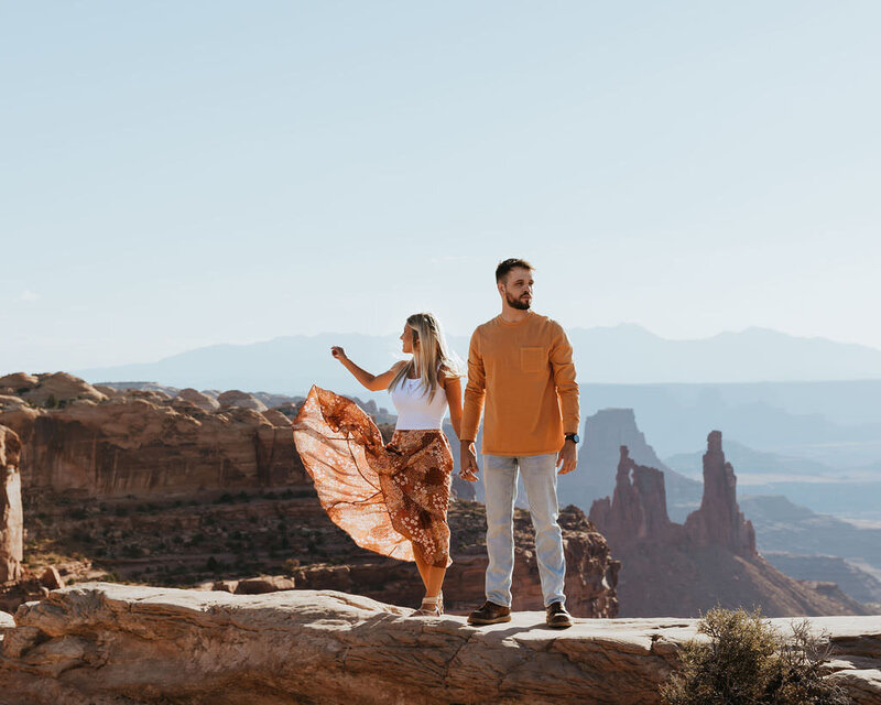 couple standing in front of mountain landscape