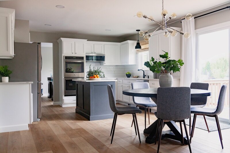Modern kitchen with white cabinets and a grey island.