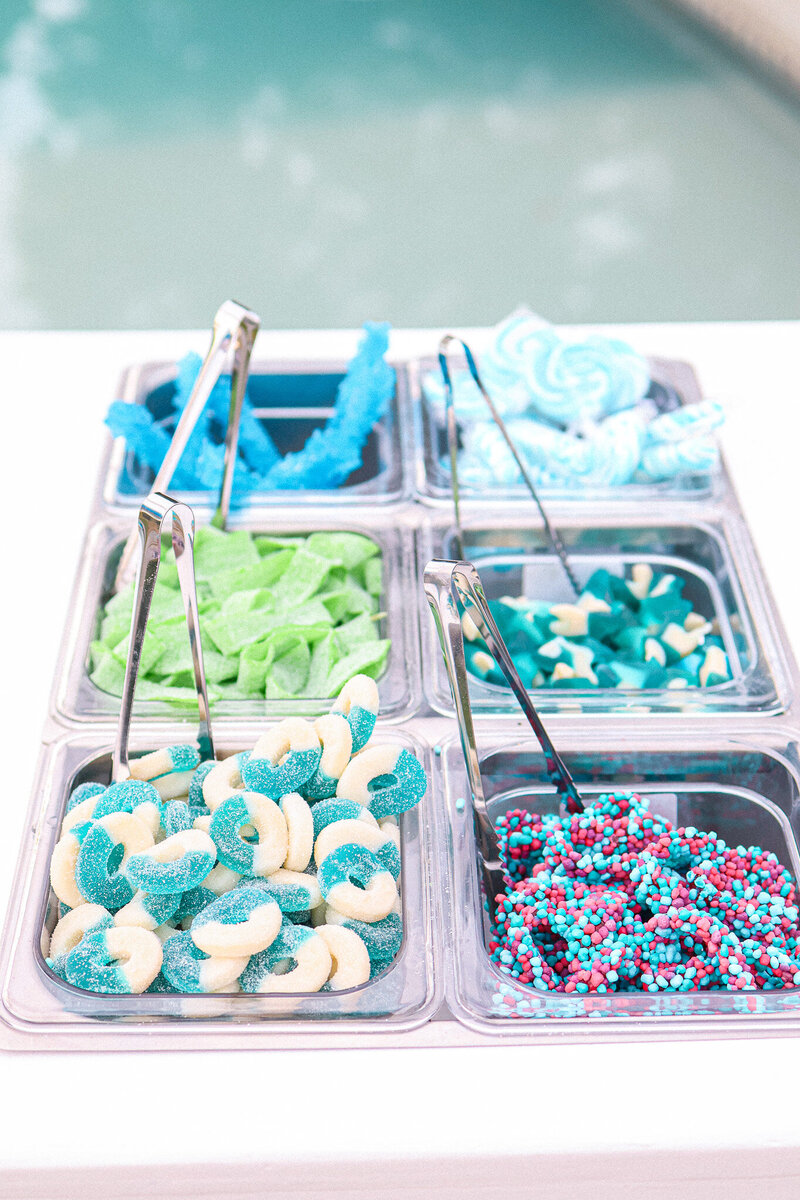 Blue and green candy toppings from a snack cart in NJ for cocktails