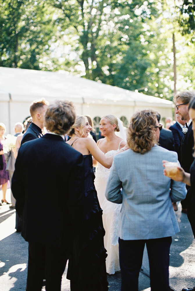 bride with her bridesmaid during cocktail hour hugging