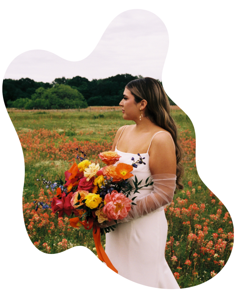 A sculptural bridal bouquet featuring vibrant seasonal blooms in bold, contrasting colors. Designed by The Floral Eclectic for a Dallas wedding.
