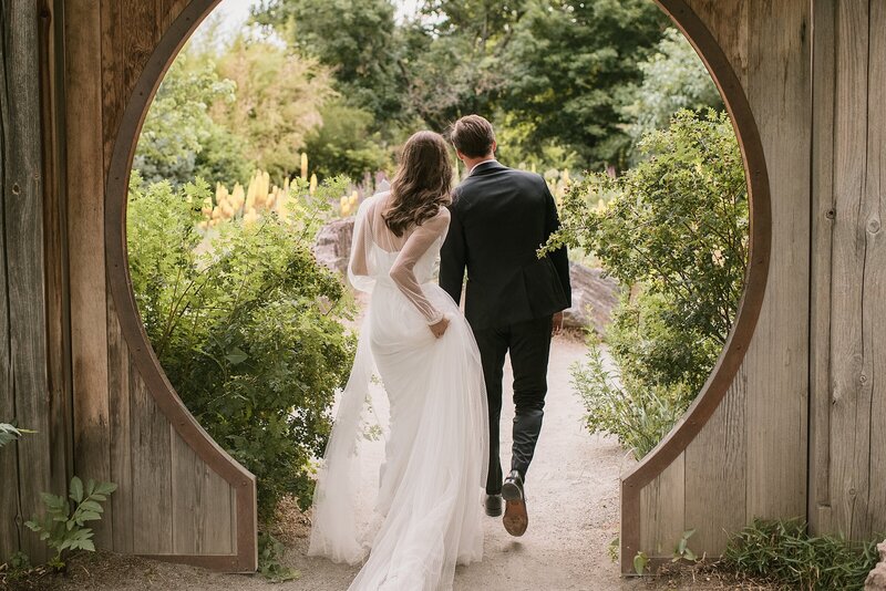 A Colorado wedding couple walks through the Denver botanic gardens