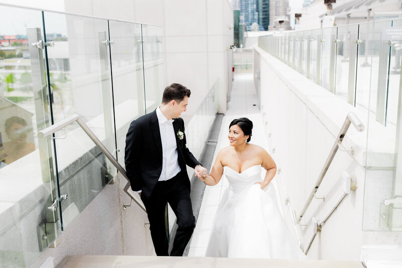 groom escorts bride up stairs at Hotel X wedding