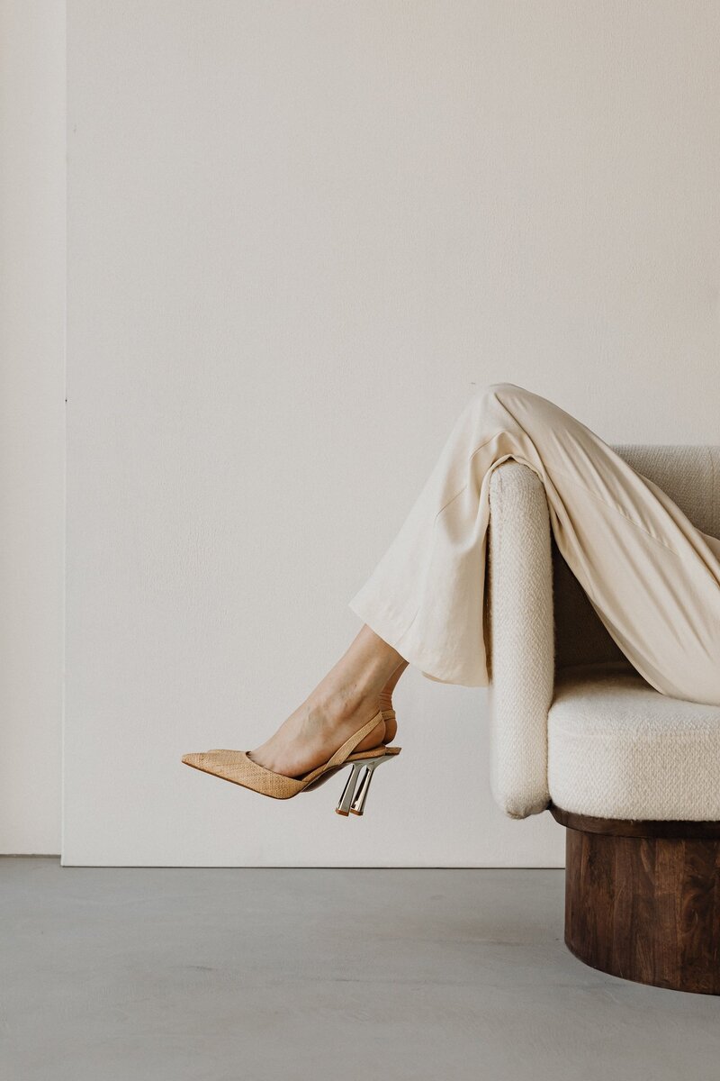 Minimalist image of woman seated in modern chair representing elevated branding for service-based businesses