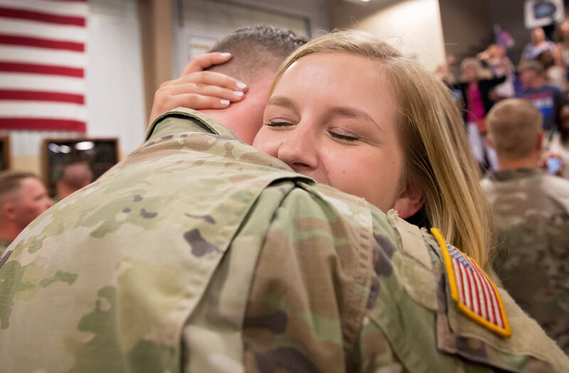 Military couple hugs emotionally upon return home in Fort Rucker