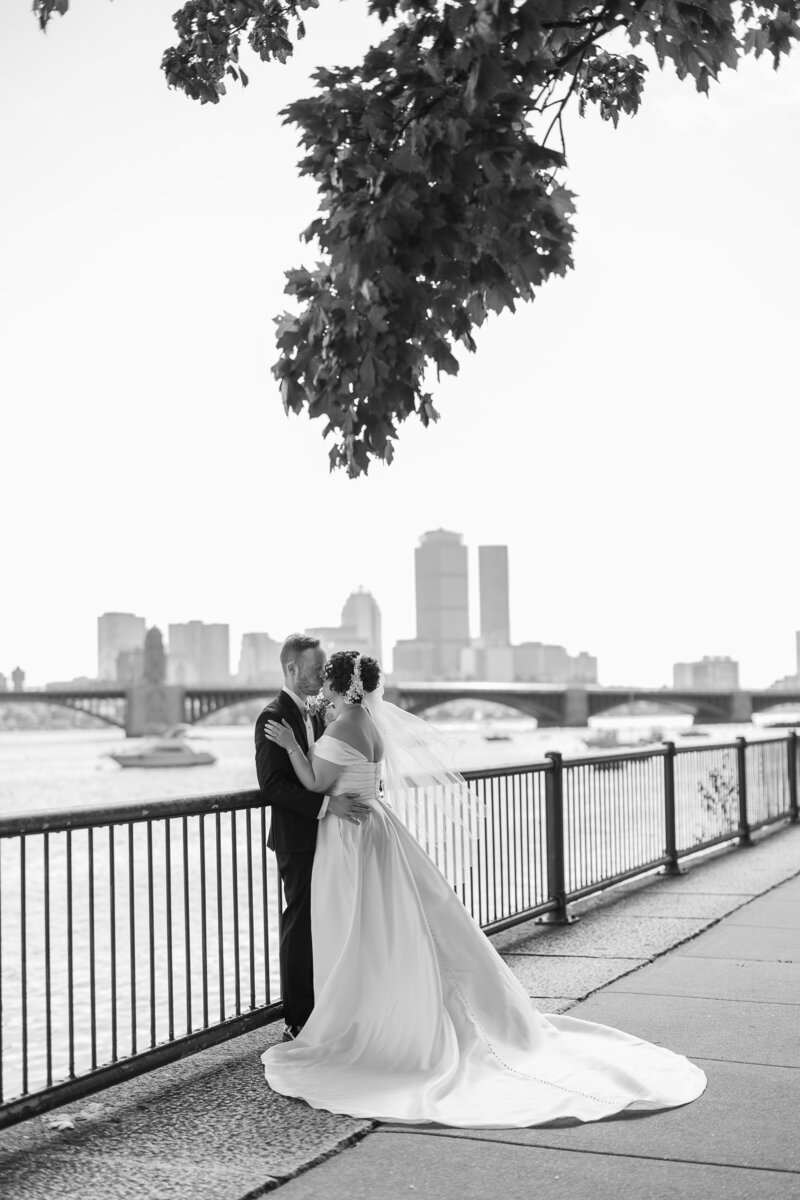 Wedding couple first look by promenade with Boston city skyline in background