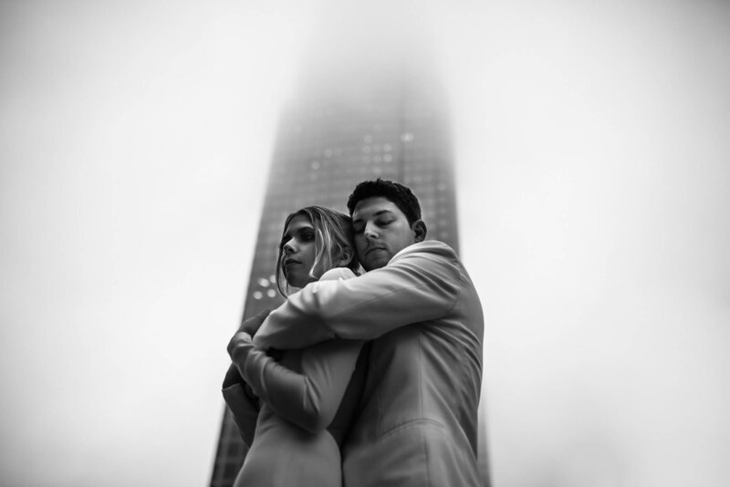 Luxury Wedding Portraits by Moving Mountains Photography in NC - Photo of a couple on their wedding day with a skyscraper in the background.