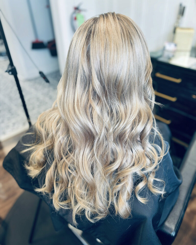 woman running hands through long curly hair