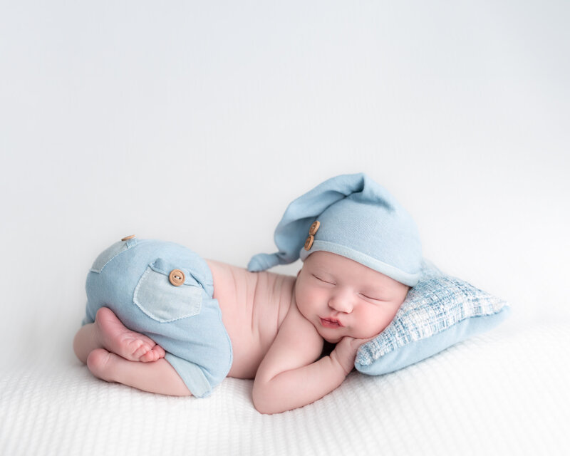Dressed in denim and dreams – a baby boy posed in soft pastels.

