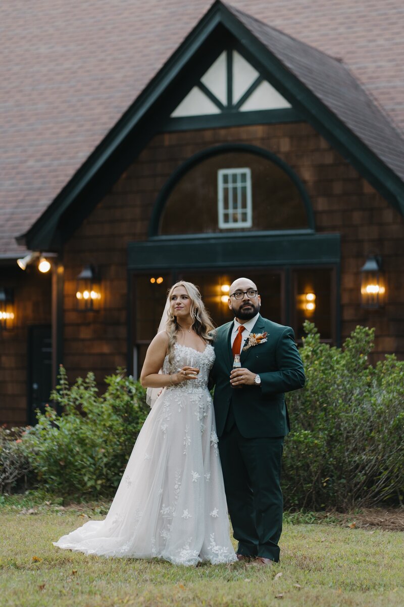 Bride and Groom sharing a drink together outside of Vecoma at the Yellow River near Stone Mountain,  looking off into the distance.