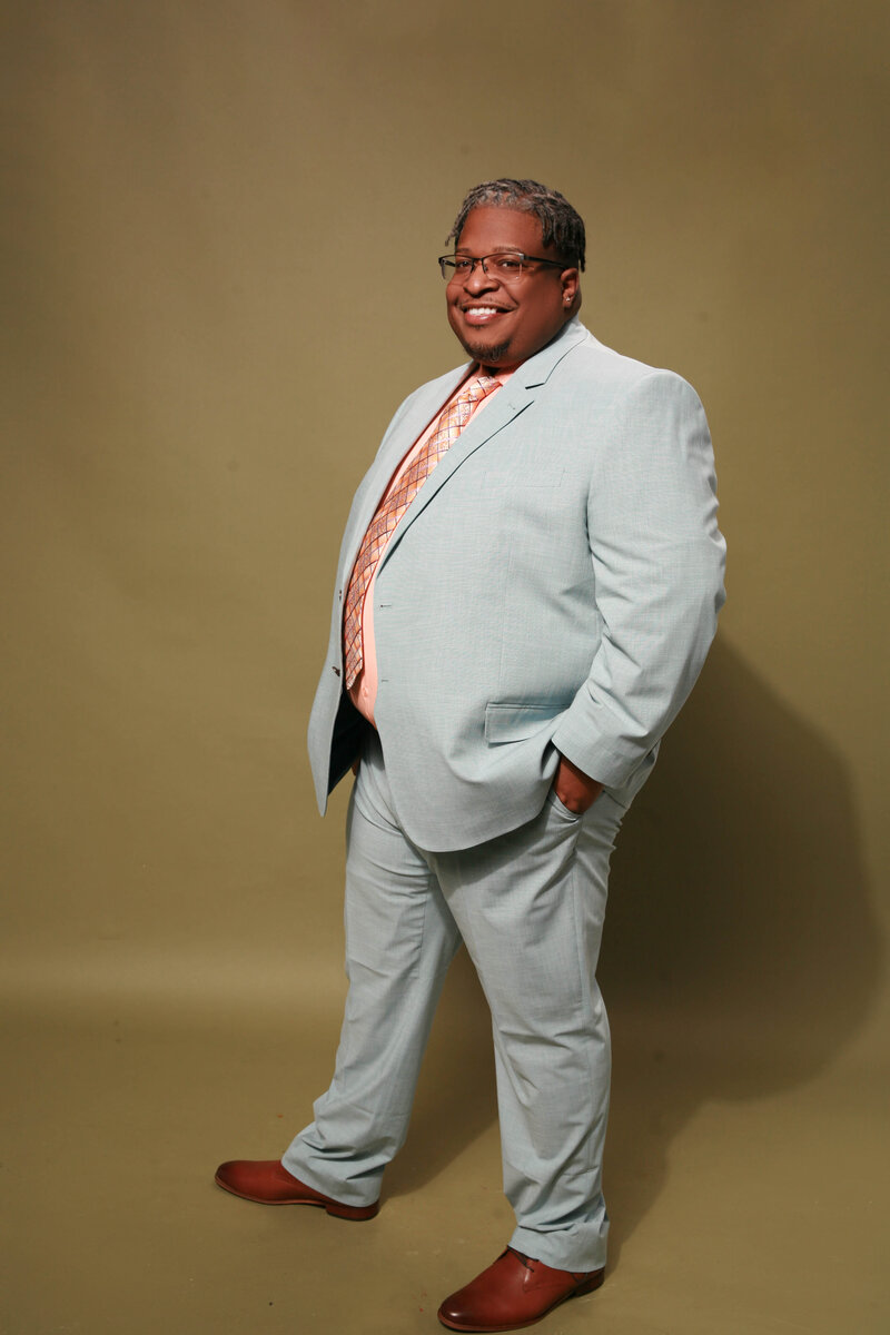 a black male therapist from Massachusetts smiling to the camera 