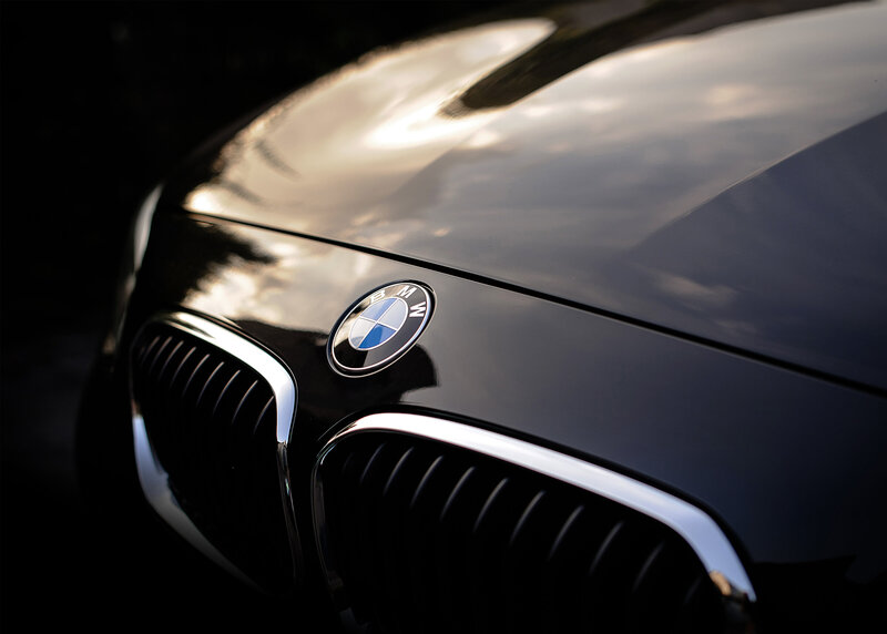 Closeup of BMW emblem on hood of car