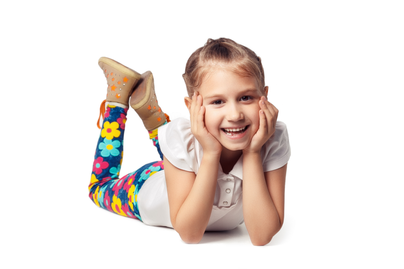 little girl laying on ground hands on face