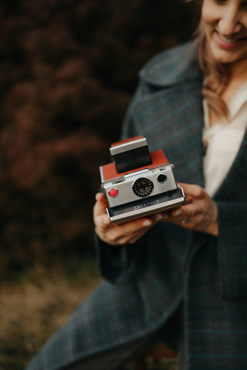 tan coloured sx-70 polaroid camera held by melbourne wedding photographer