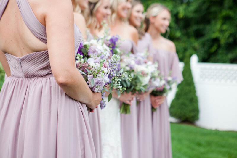 Close up of bridesmaids dresses and flowers