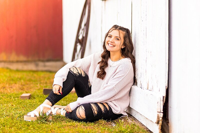 Senior girl smiles during fall senior session in Londonderry, New Hampshire