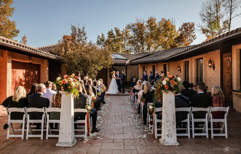 A Fall Wedding Ceremony Outdoors in the Courtyard at Villa Parker in Colorado