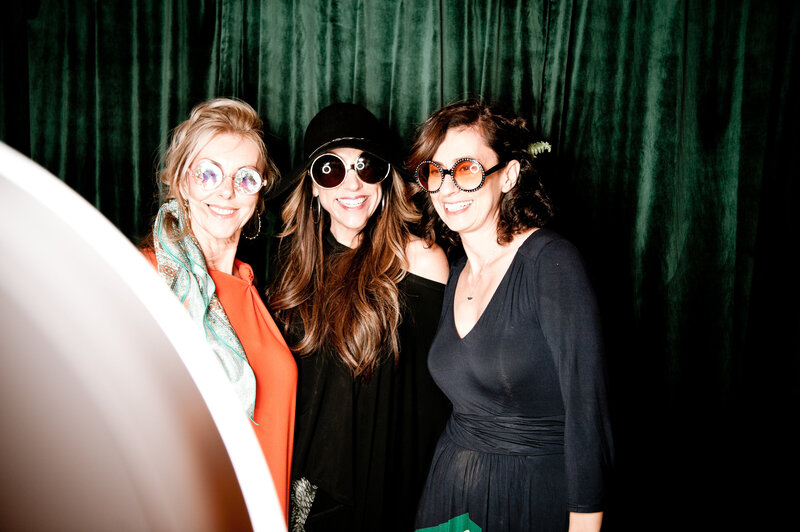 Three guests wearing oversized glasses pose for a fun photo booth moment at a corporate celebration in Phoenix, Arizona.