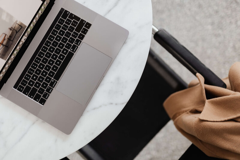 Two female business owners working on laptop and making notes